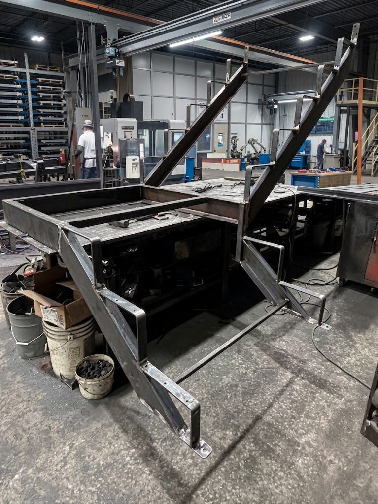 Welded steel frame assembly with angled uprights on the shop floor