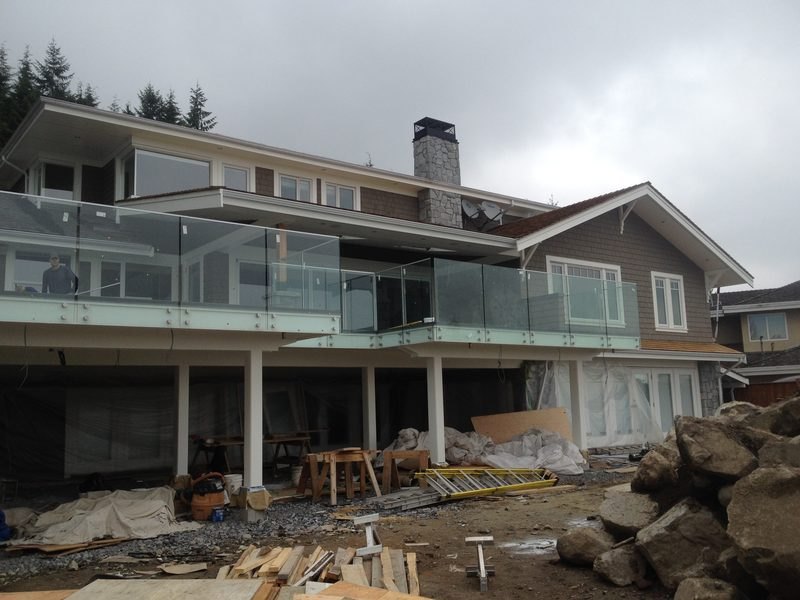 Glass railings on the upper decks of a new home under construction