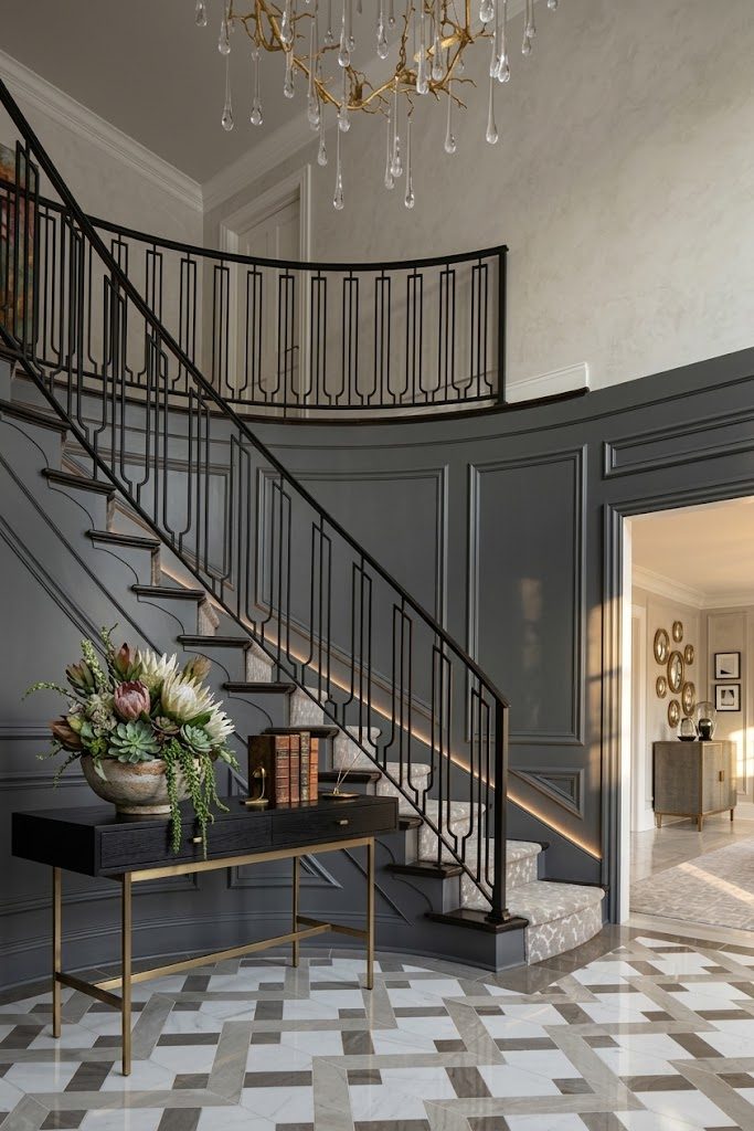 Art deco style steel stair and balcony railing in a two-storey foyer