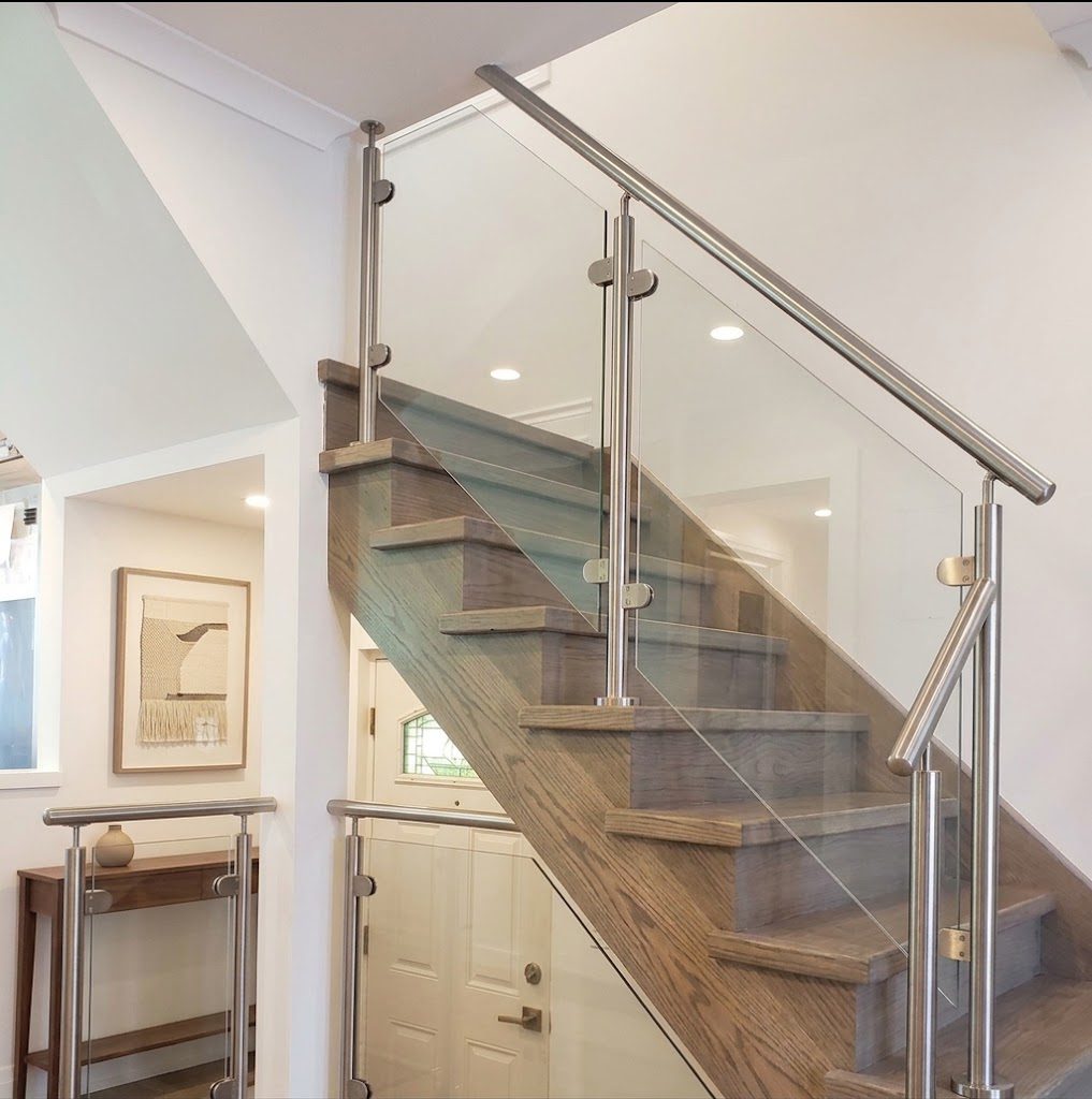 Steel and glass interior stair railing on an open-riser staircase